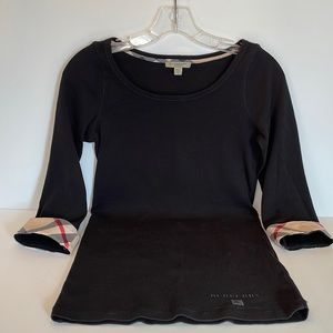 Burberry 3/4 sleeve t-shirt with plaid cuffs.